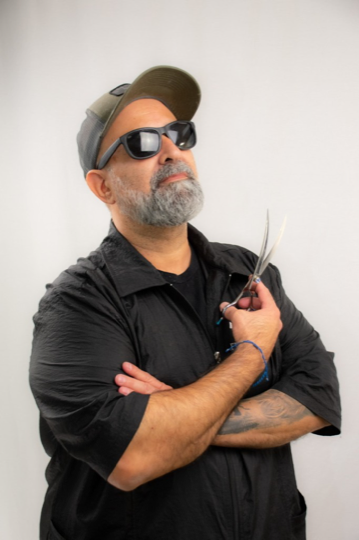 Mauricio D, founder of Withers, holding grooming shears